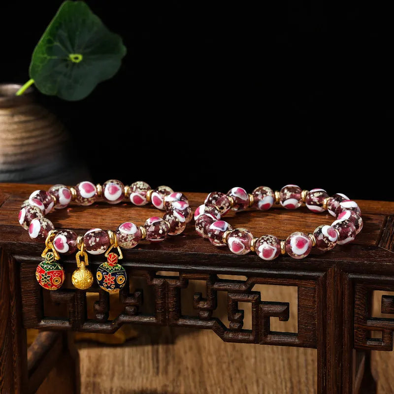 Handmade glass bracelet with swallowing gold beast design on heart-shaped 10mm beads