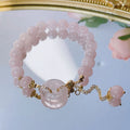 Pink crystal bracelet with peace buckle closure on woman's wrist