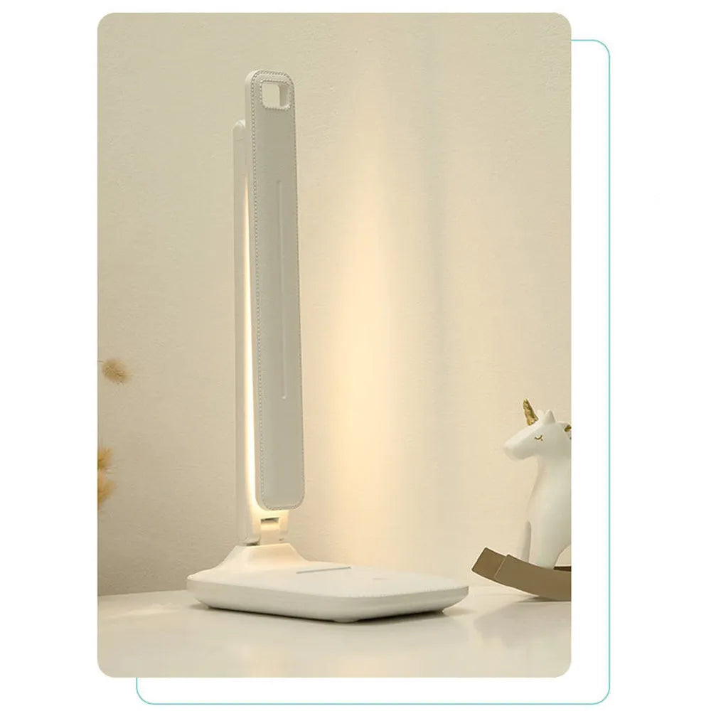White plastic children's bedside lamp with touch dimming control and USB charging port.