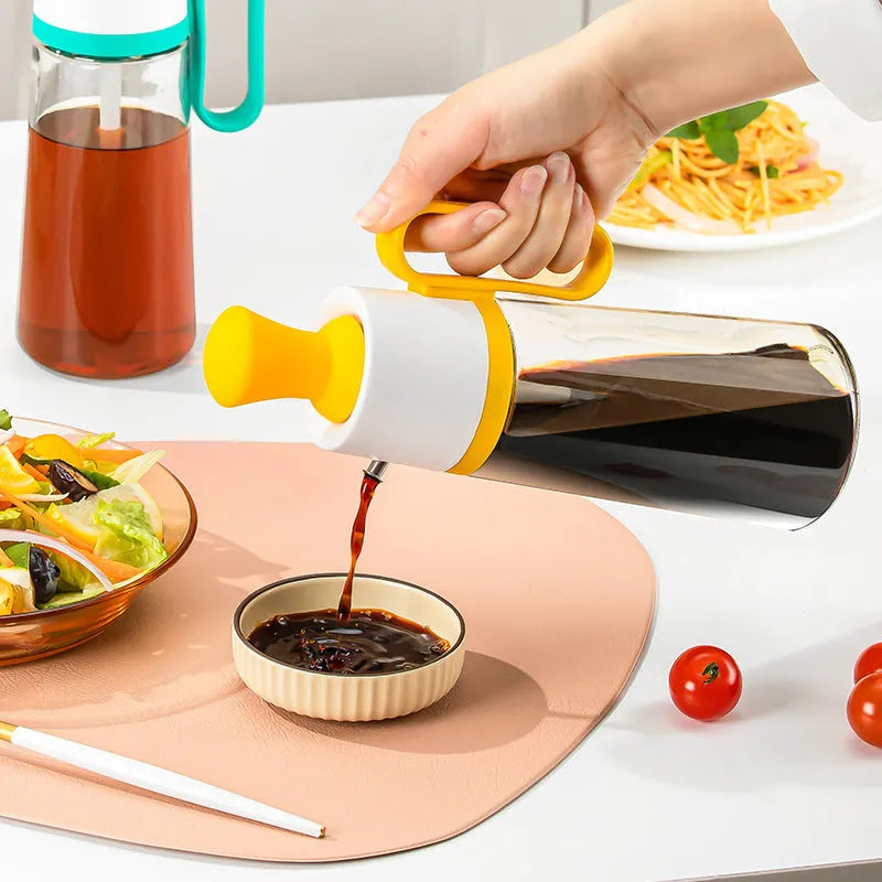 Yellow 2 in 1 oil dispenser with silicone brush next to glass bottle