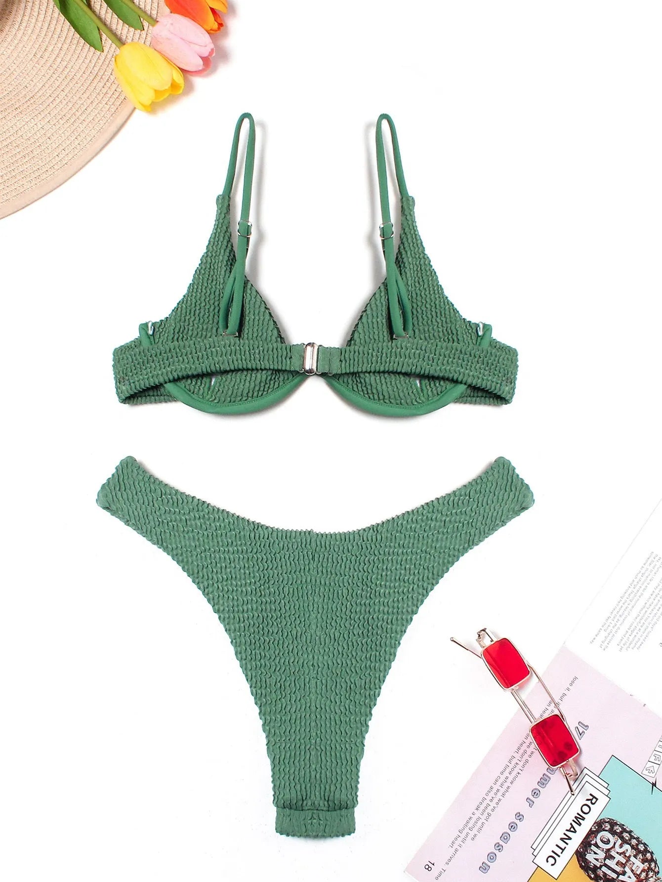 Women's solid green bikini suit with ruffle trim and split leg briefs on a mannequin.