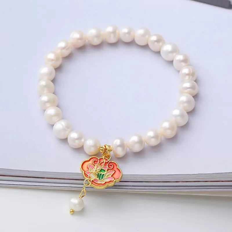 White freshwater pearl bracelet with goldfish pendant and water ripple design in vintage baroque style