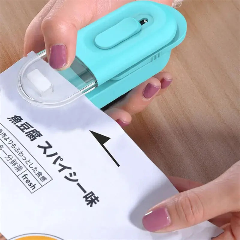 Multi-functional handheld portable food storage bag sealer with cutting head in black, white, and lake blue