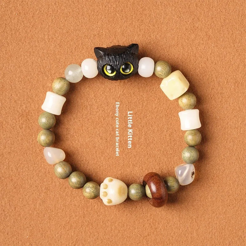 Hand-woven adjustable bracelet with bodhi seeds, jade beads, and a cartoon cat's paw guajacwood charm