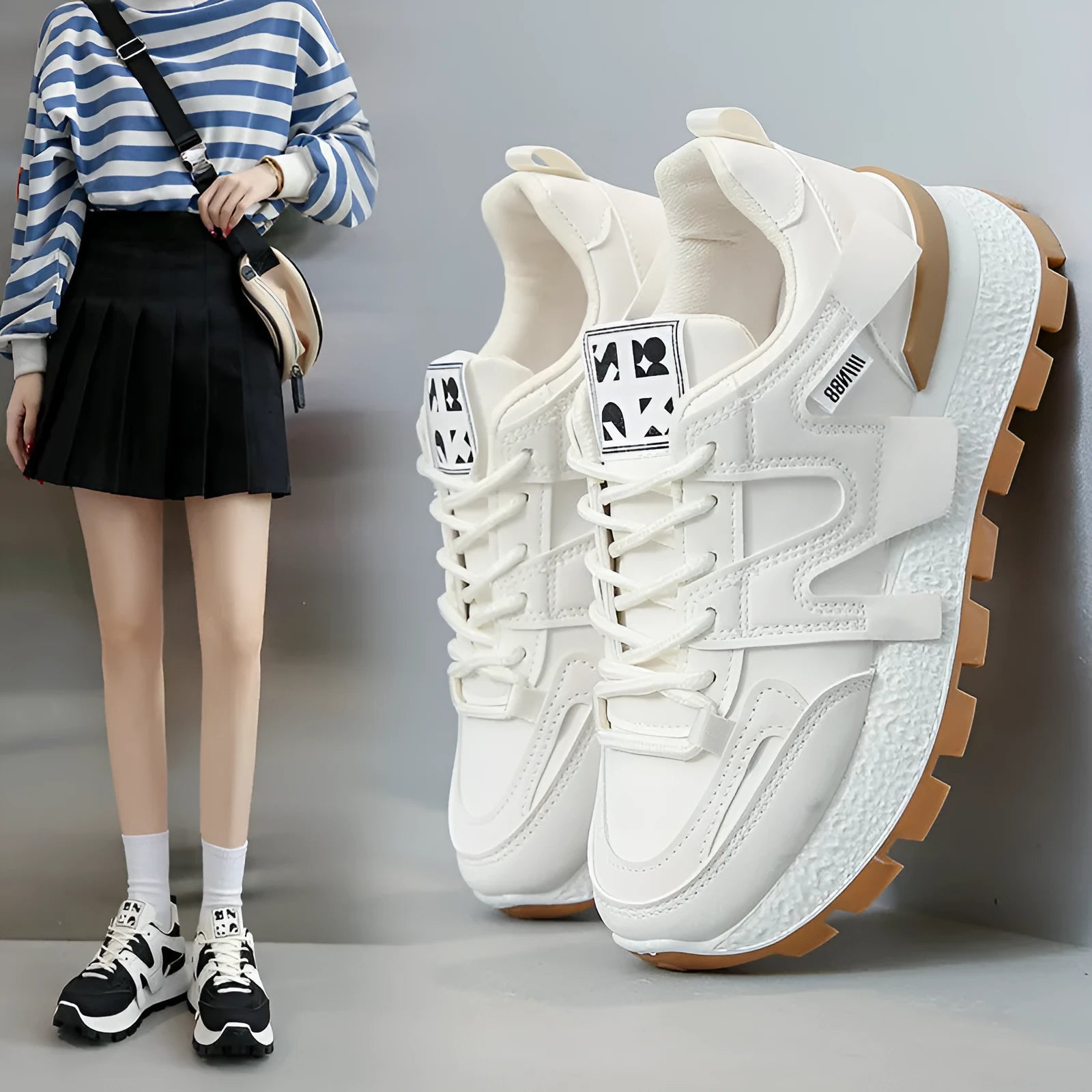 Low top running sneaker in white with round toe and lace-up front on rubber sole