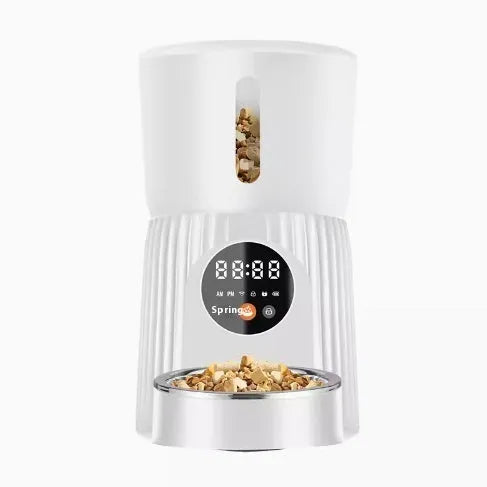 Black and white automatic pet feeder with digital display, food hopper, and USB cable.