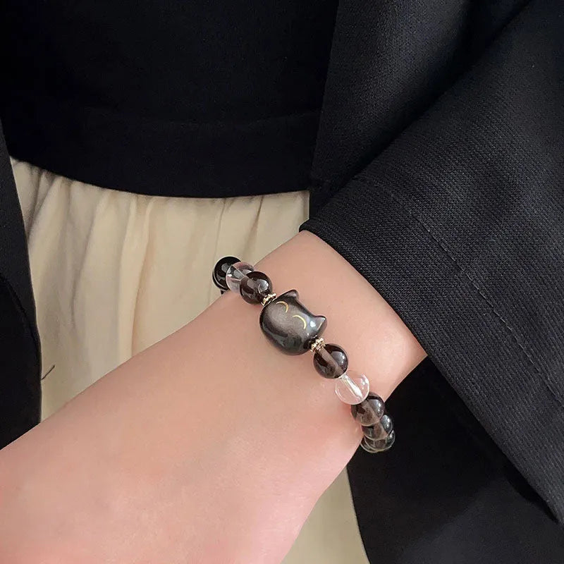 Women's silver bracelet with 8mm opal cat head charm on wrist
