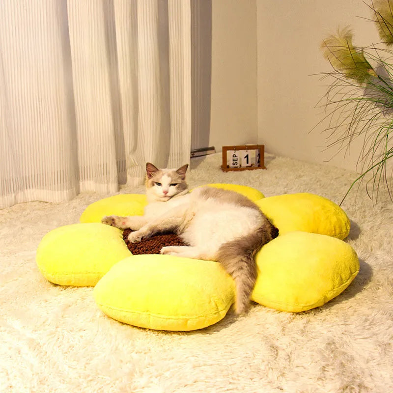 Round blue cat bed with high plush walls and soft filling, shown on a wooden floor.