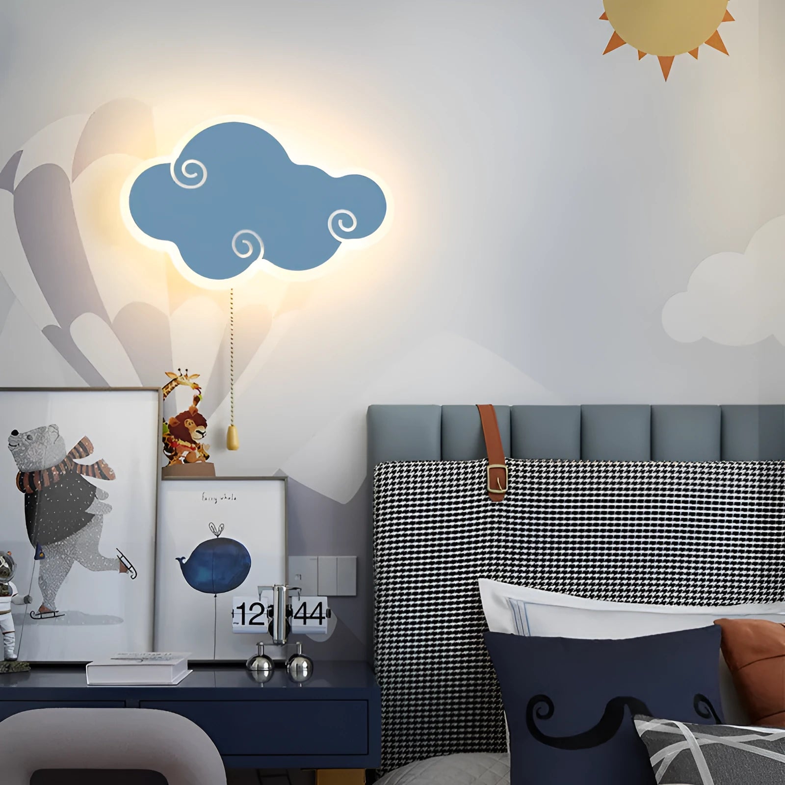 Modern white cloud-shaped acrylic wall lamp lit with a soft warm glow on a bedroom wall.