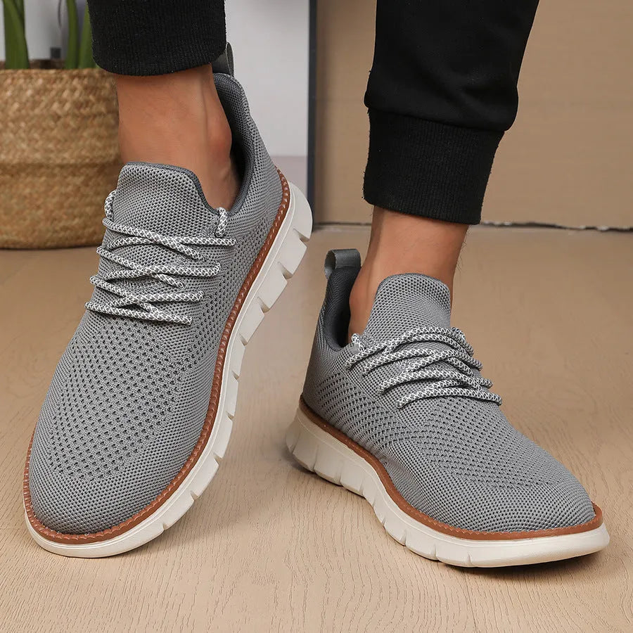 Men's grey and black mesh fabric casual sneakers with low heel and round toe.