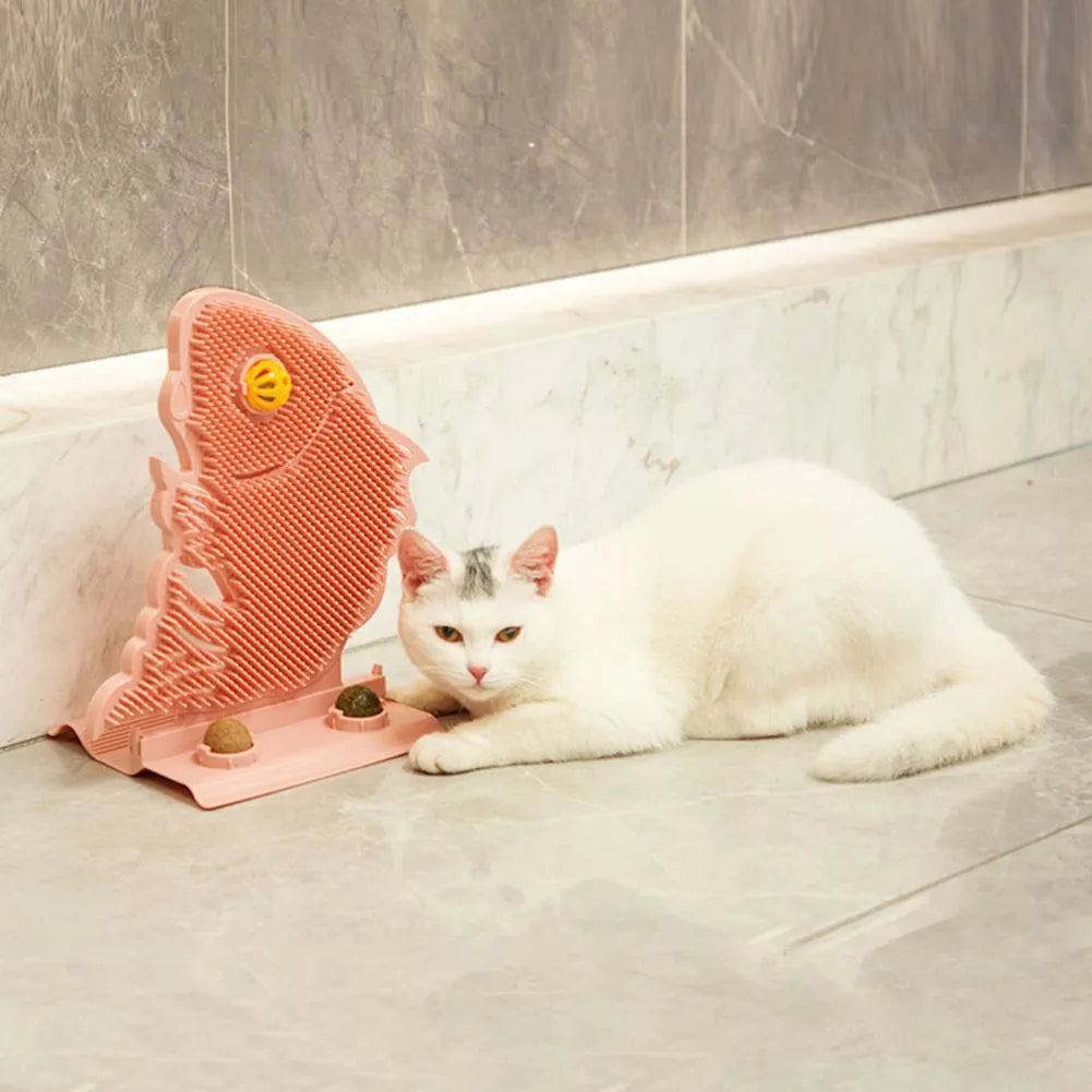 Blue fish-shaped cat wall scratcher toy with brush, catnip balls, and a bell on a white base.