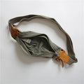 Green American retro military style chest bag with washed canvas and cowhide leather details