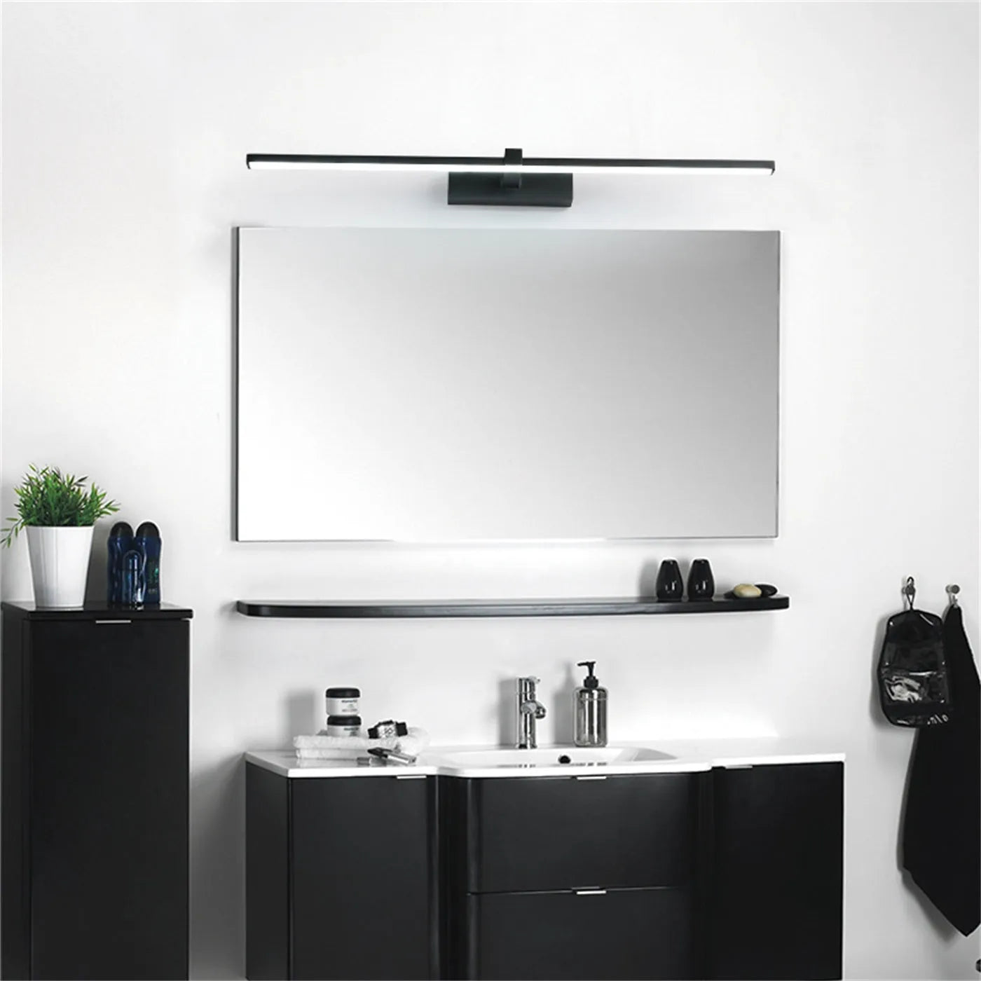 60x8cm black LED bathroom wall lamp with push button switch mounted above a vanity mirror