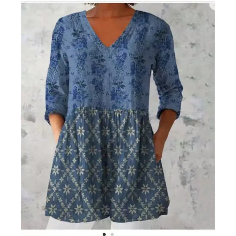 A loose-fitting women's dress with a wave print, 3/4 sleeves, and a wide waist.
