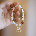Chinese-style glass bracelet with coloured glaze, fu character, safety lock, windmill and bamboo presages charm designs