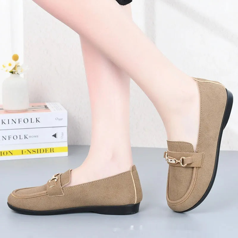 Gommino women's black slip-on casual shoes with a round toe and soft rubber sole on a neutral background.