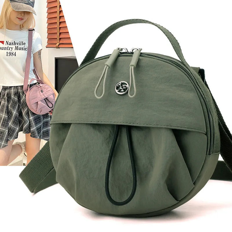 Nylon messenger crossbody bag with out shoulder design showing internal phone and document compartments