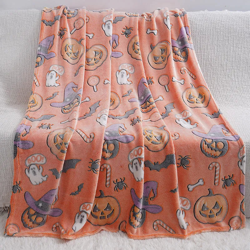 Colourful cartoon print flannel blanket shown draped over a sofa and next to an air conditioner unit.