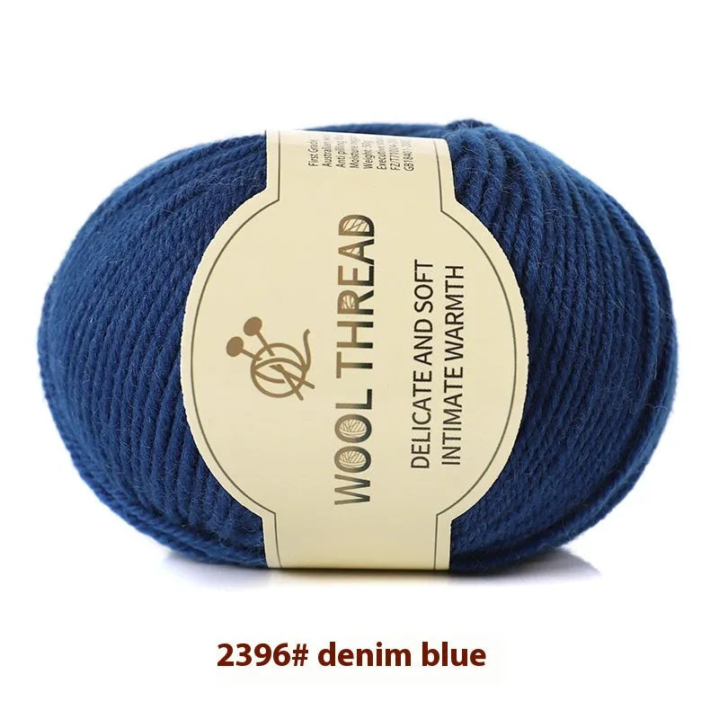 One roll of beige domestic wool hand-knitting yarn for size 10 needles next to knitting needles.