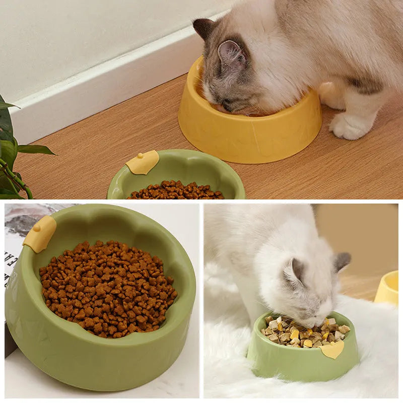Green flower-shaped plastic double bowl for cat or small dog food and water on a plain surface.