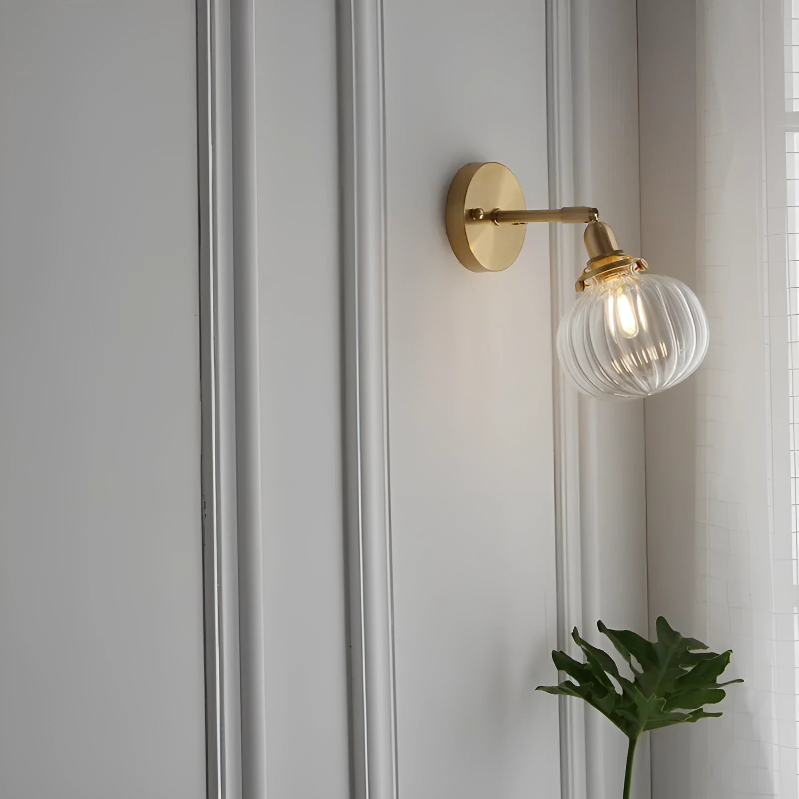 Creative pumpkin-shaped wall lamp with a textured glass shade mounted on a white wall.