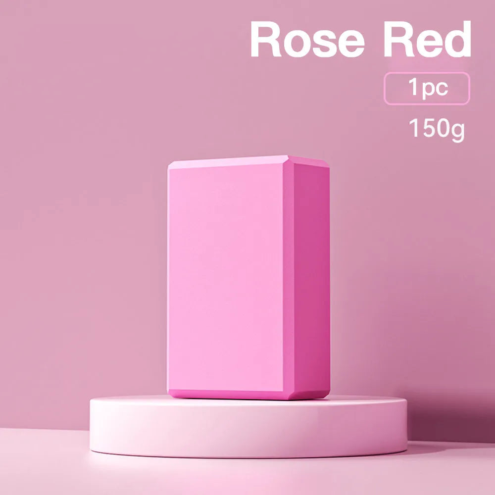 Solid blue EVA foam yoga brick with ridged hexagonal surface, shown next to a pink block.