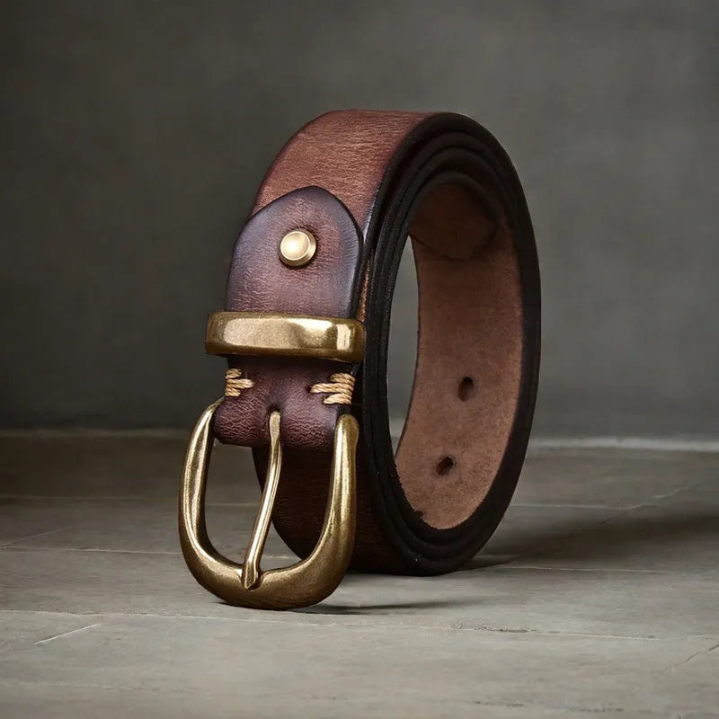 Men's brown leather belt with copper pin buckle on a flat surface