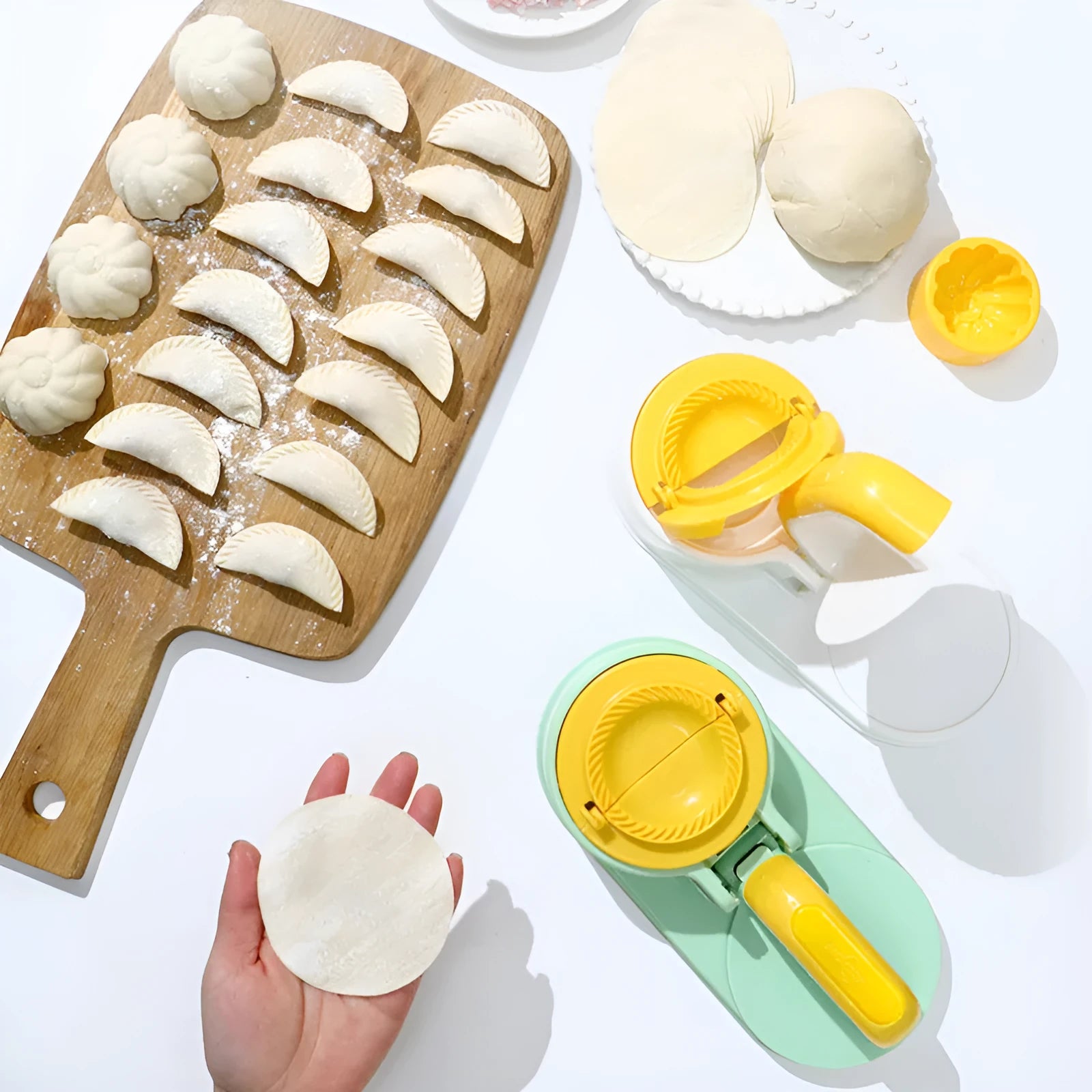 Plastic dumpling wrapper pressing device in fresh green colour on kitchen surface with dough