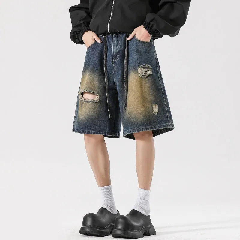 Loose-fit ripped jeans in retro blue denim, shown on a model, highlighting the baggy fit and distressed details.