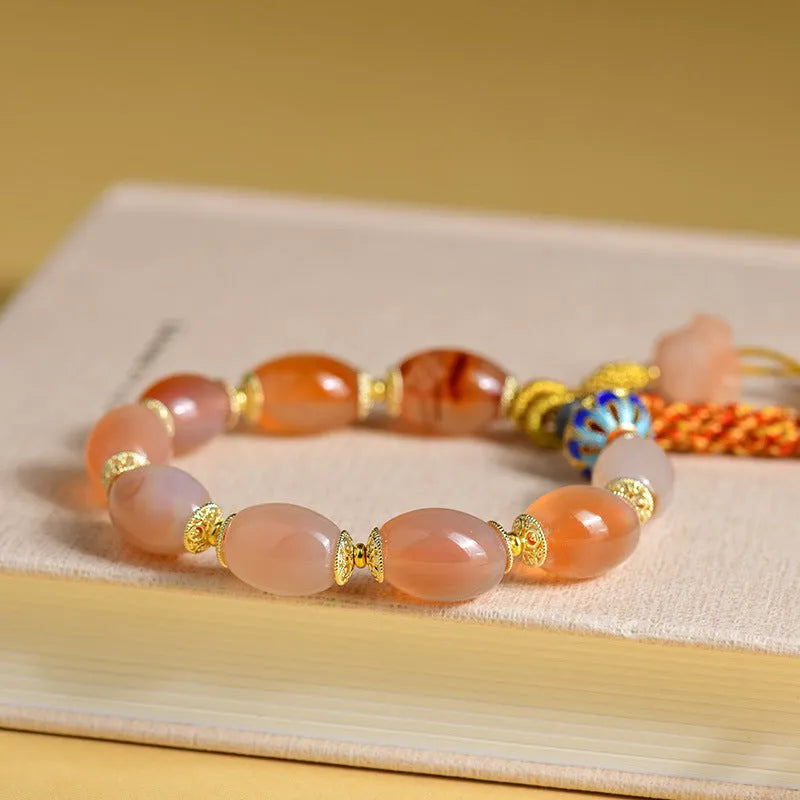 Vintage Tibetan agate bracelet with floral and geometric patterns including lily motif