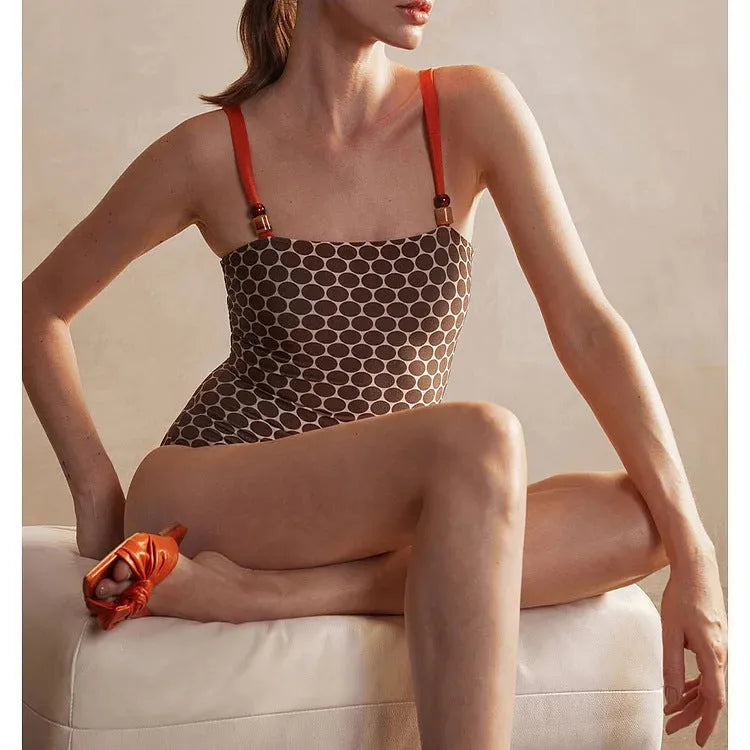 Women's printed dot one-piece swimsuit with a matching wrap skirt, shown on a mannequin.