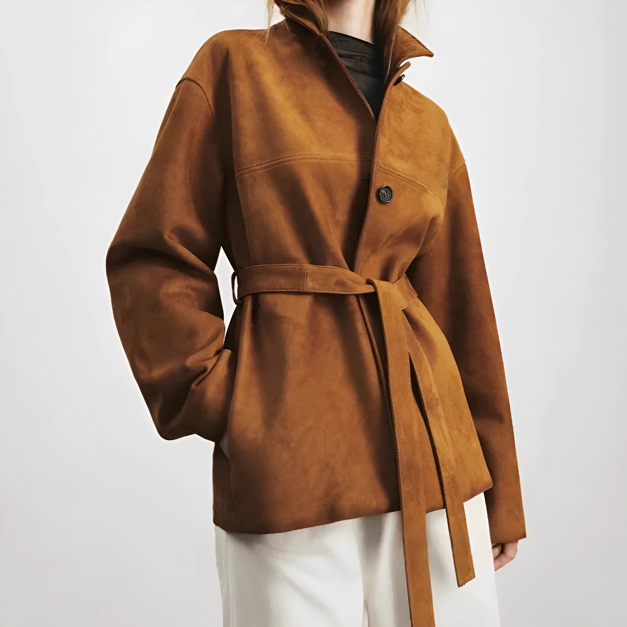 Yellow brown mid-length cashmere coat with a Peter Pan collar and decorative leather stitching on the front.