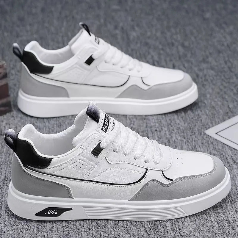 Men's low-top canvas board shoes in grey with leather stitching detail on a white background.