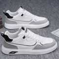 Men's low-top canvas board shoes in grey with leather stitching detail on a white background.