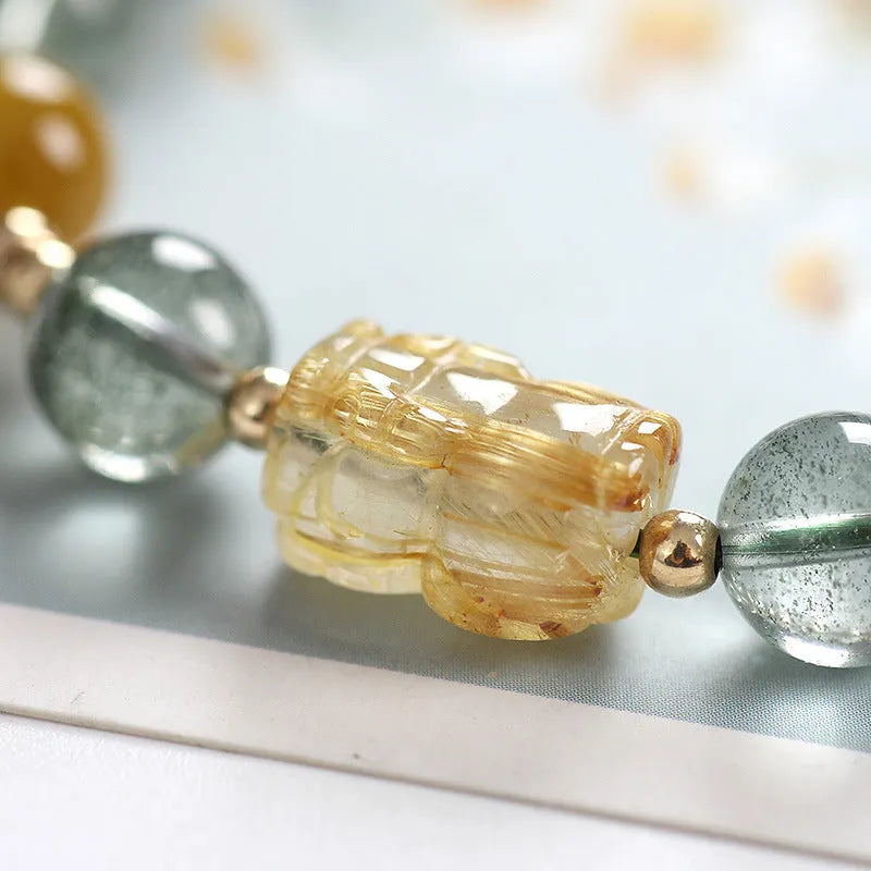 Green phantom quartz bracelet with geometric charm and gold rutilated quartz stones
