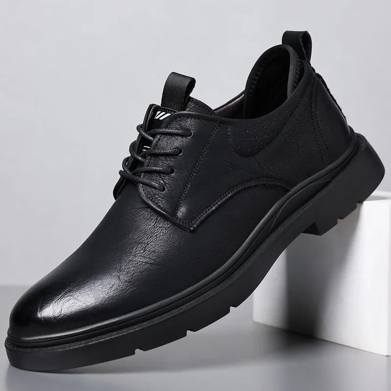 Men's black leather casual sneakers with sewing line detail on a two-layer cowhide upper and rubber sole.