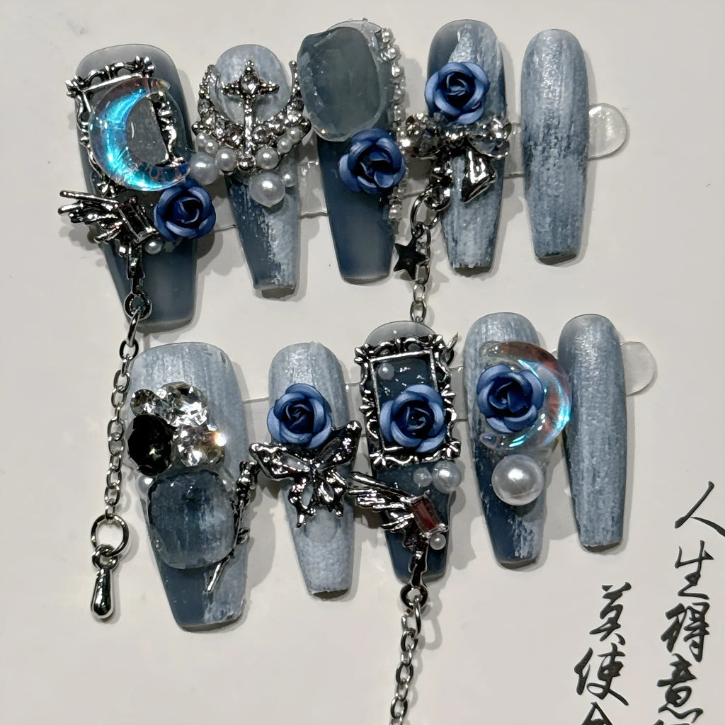 Ornate rose and tulip pattern nail wraps in deep blue night colour on a plastic armour suit.