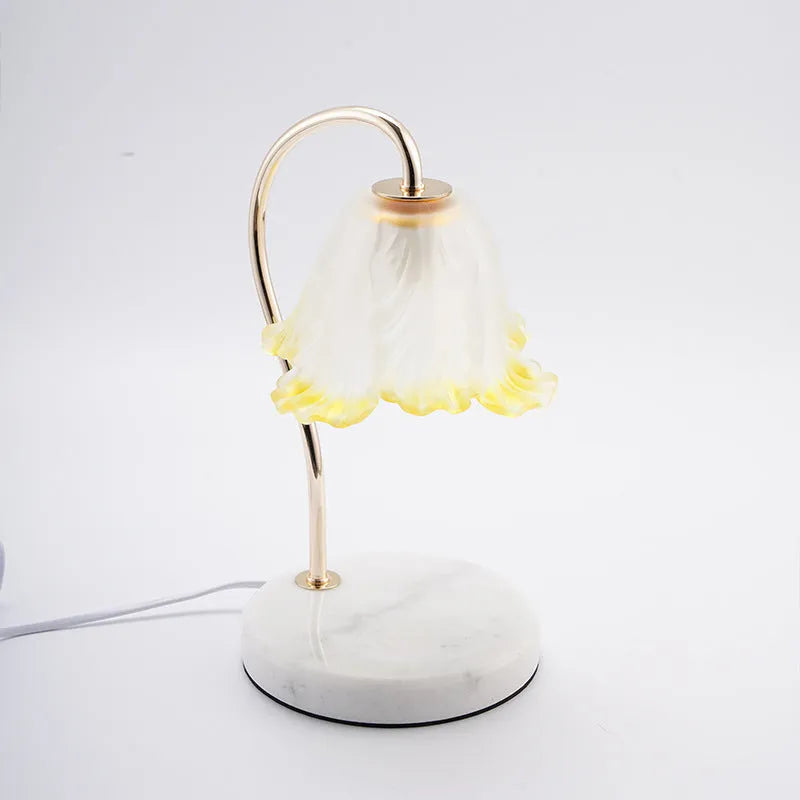 Candle light log aromatherapy table lamp with glass lampshade on nightstand, two bulbs lit, natural wood base