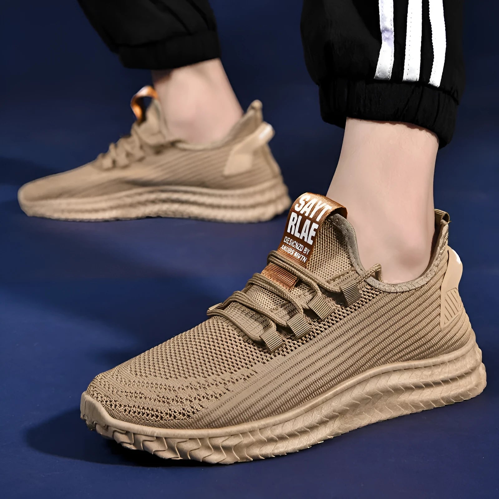 Men's casual shoes with black flying weave upper, rubber sole, and front tie lacing