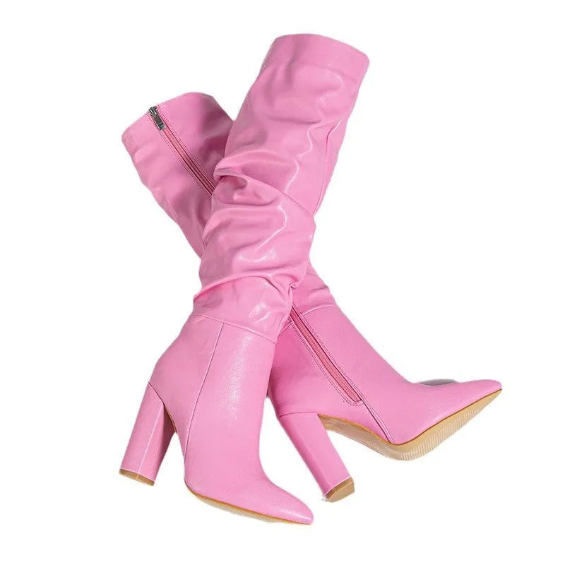 White women's pointed toe high heel boots with side zipper on a model.