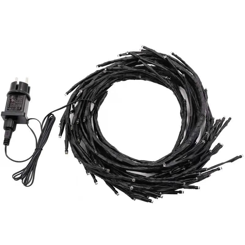 Flexible LED willow vine garland with warm white lights shaped into decorative curve