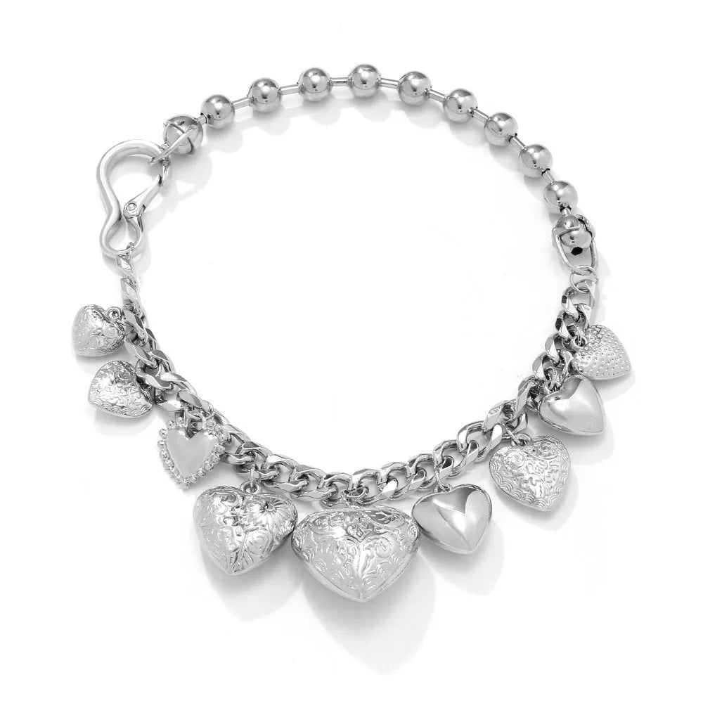 Exaggerated carved heart-shaped alloy pendant necklace on an adjustable metal chain.