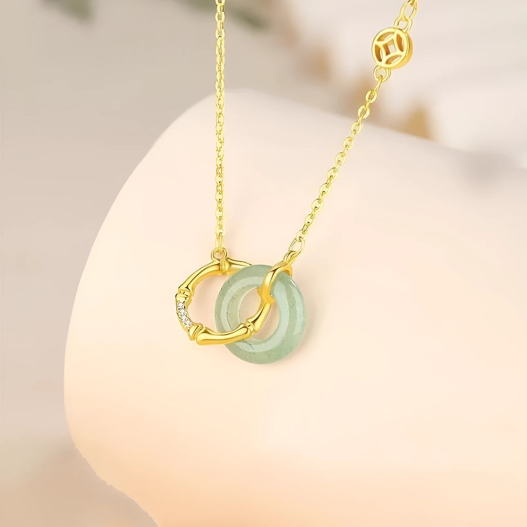 Sterling silver bamboo buckle necklace on geometric O-ring chain, showing adjustable length and pearl detail.