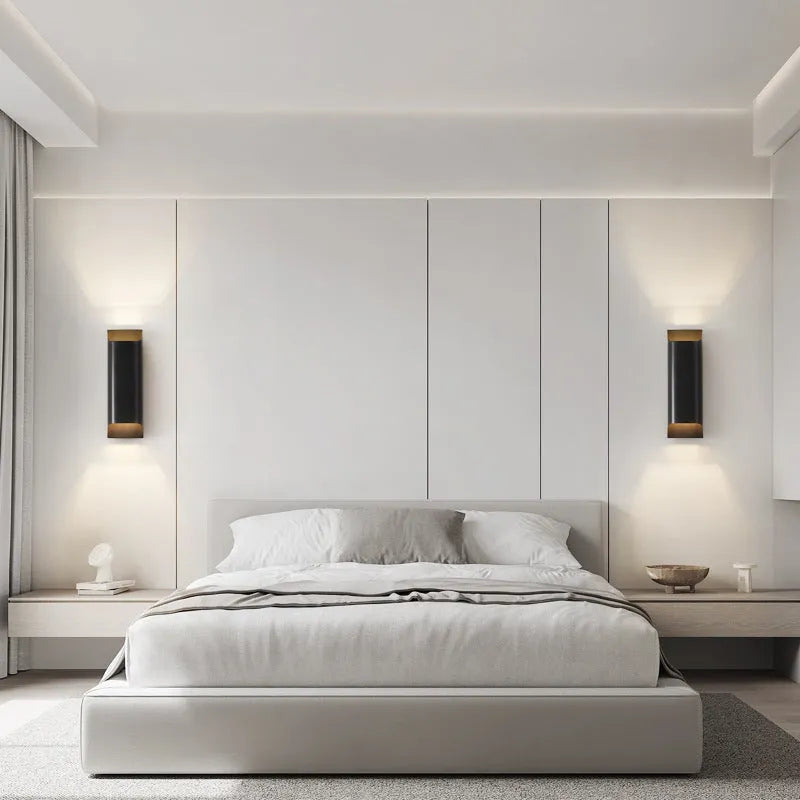 Minimalist copper wall lamp with black gold finish mounted beside bed