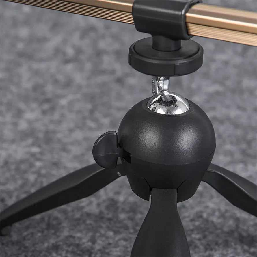 Aluminium ice fishing rod holder bracket with a tripod base on ice.