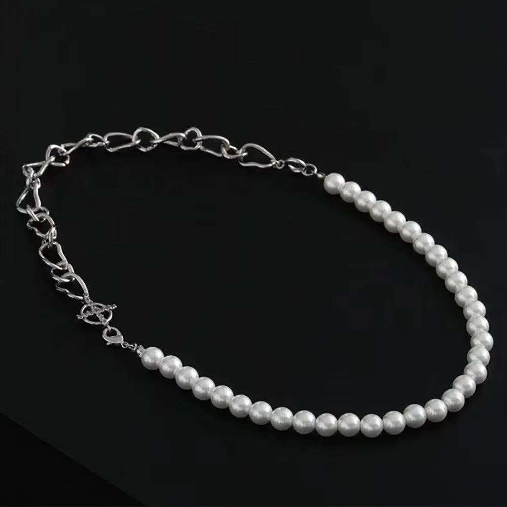 White geometric asymmetric acrylic pendant necklace on a twisted metal chain, shown against a neutral background.