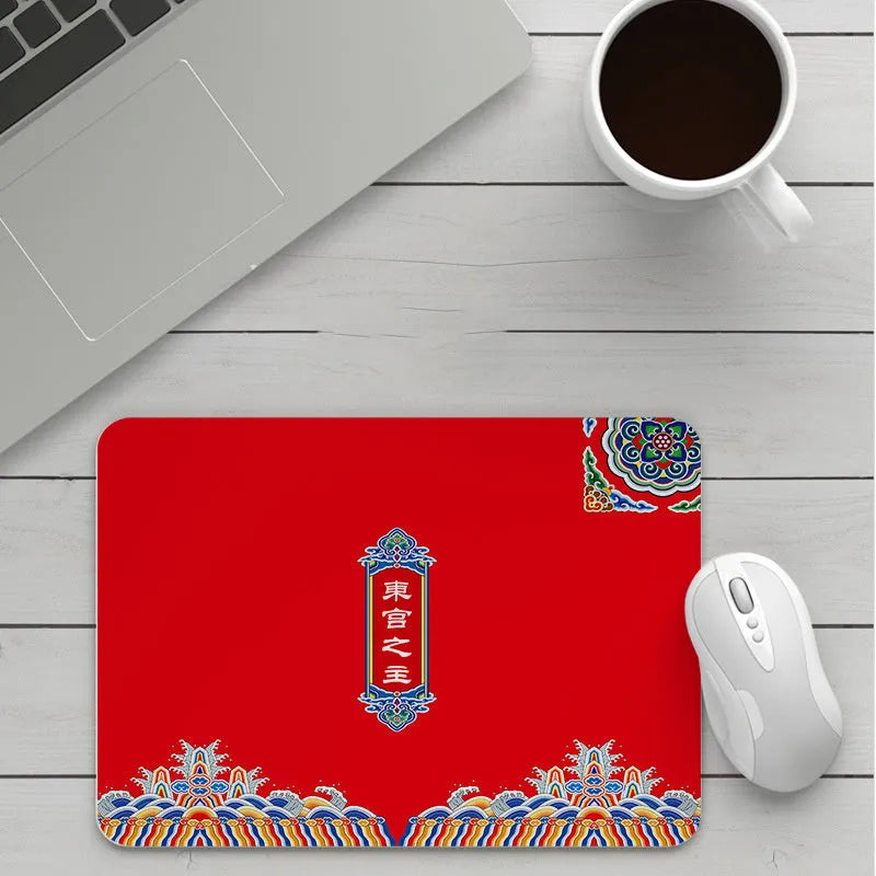 Thick custom cartoon mouse pad with colourful design on a desk, showing black seam edge