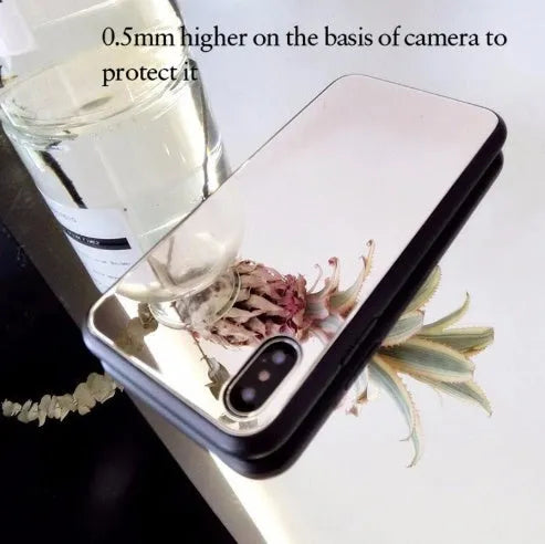 Black mirror back cover phone case for Apple iPhone X, 11, 12, 7, 8, and 6 models on a table.