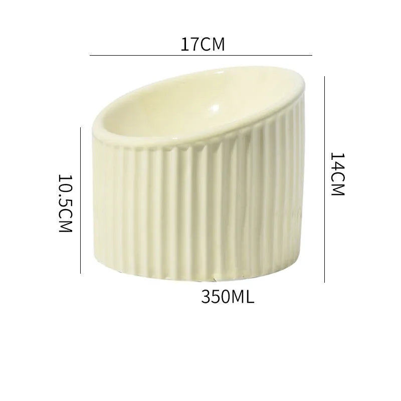 Ceramic elevated cat food bowl in green, showing tilted round dish on a raised stand.
