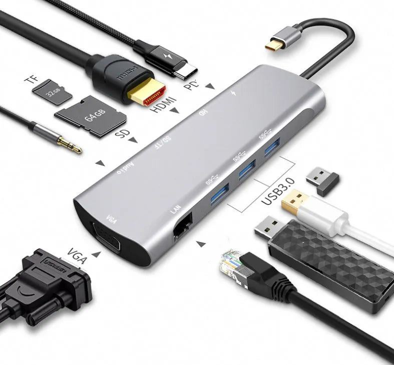 Grey aluminium USB-C docking station with HDMI, VGA, USB 3.0, and PD charging ports on a desk.